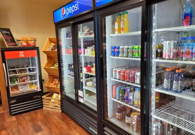 Shop local gifts, apparel, and resort keepsakes at The Elk Trader Osthoff Resort merchandise and souvenirs displayed in The Elk Trader gift shop and mini market.