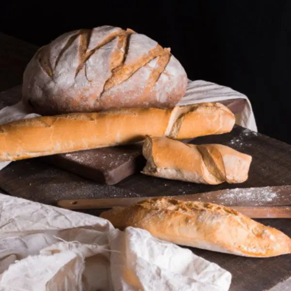 Guests participating in a hands‑on artisan breadmaking workshop, learning to bake a variety of breads.