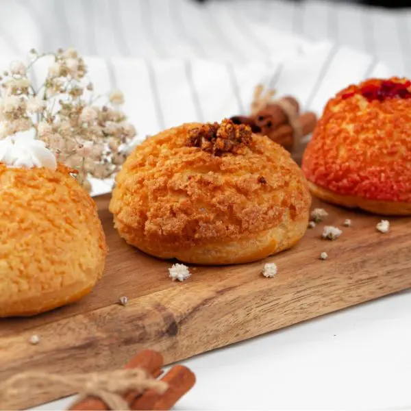 Guests preparing choux pastry, including gougères, cream puffs, and éclairs, during a hands‑on cooking class.