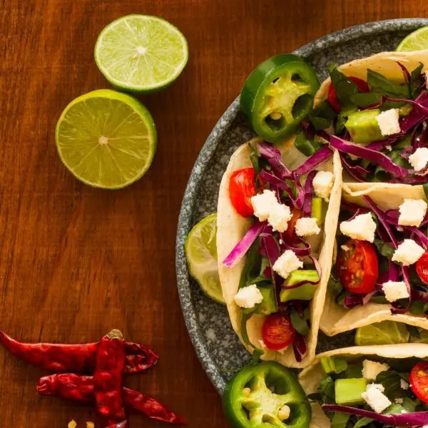 Guests preparing Mexican dishes including pico de gallo, Mahi Mahi tacos, and rice pilaf during a hands‑on cooking class.