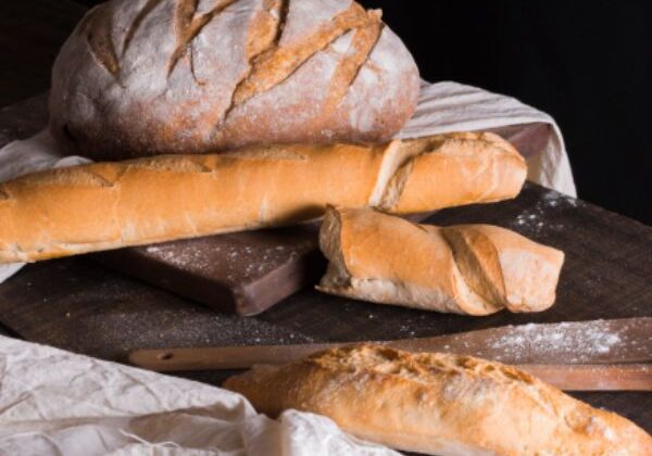 Guests participating in a hands‑on artisan breadmaking workshop, learning to bake a variety of breads.