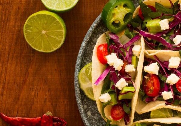Guests preparing Mexican dishes including pico de gallo, Mahi Mahi tacos, and rice pilaf during a hands‑on cooking class.