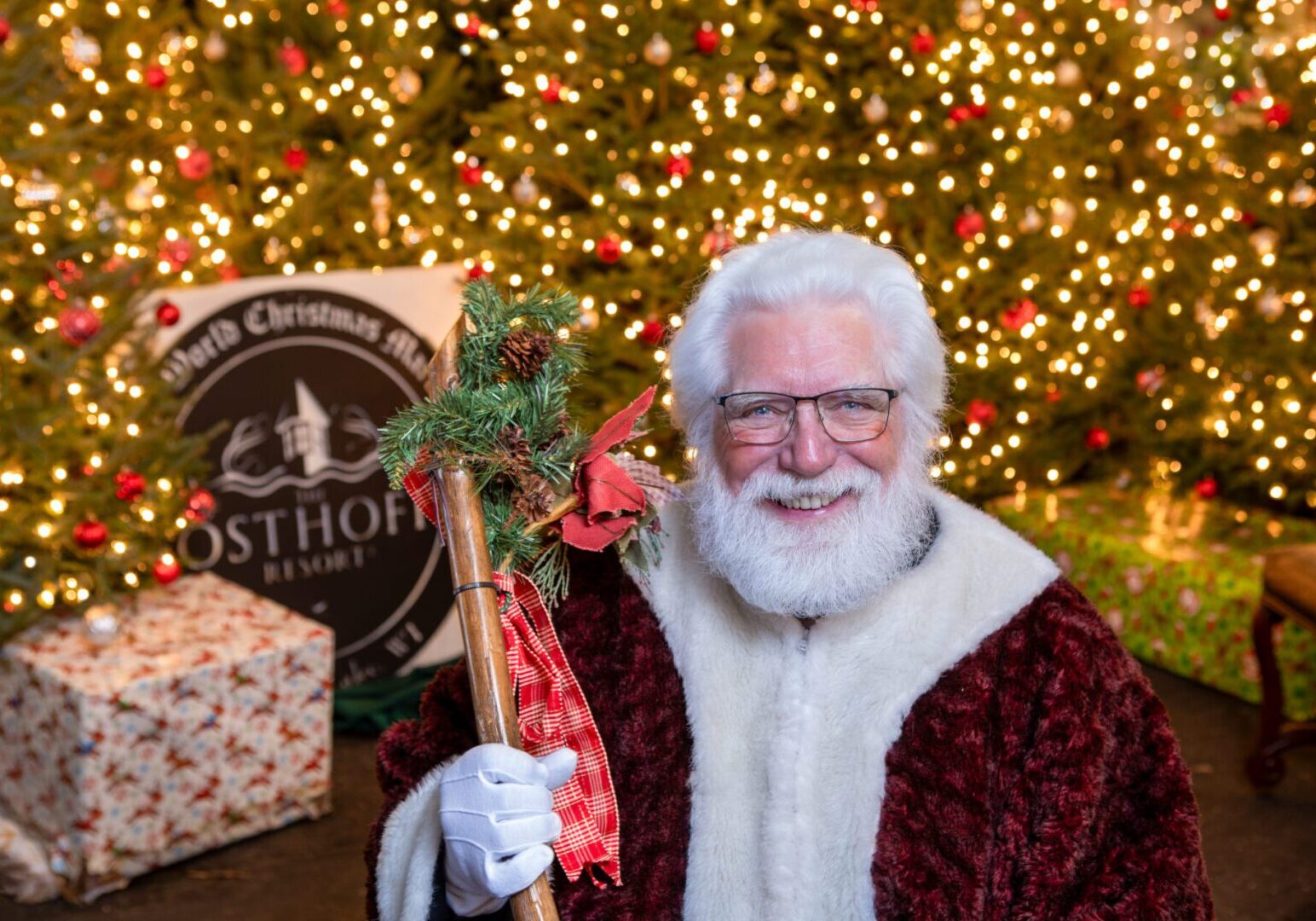 Santa greeting guests at the Old World Christmas Market at The Osthoff Resort with festive holiday décor.