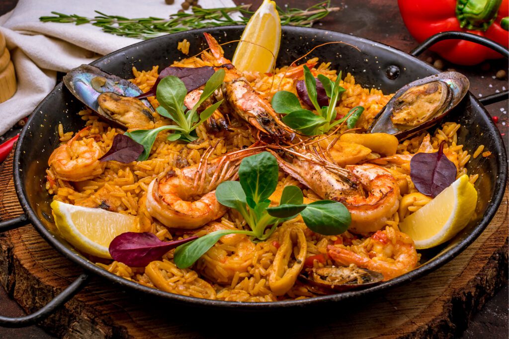 Hands‑on paella cooking class at The Osthoff Resort featuring seafood paella, Spanish wines, and tapas.