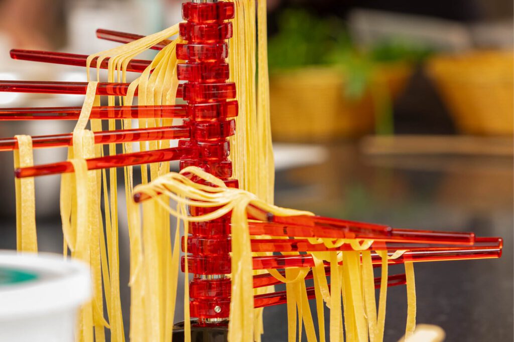 Handmade pasta cooking class at The Osthoff Resort featuring fresh fettuccine, farfalle, agnolotti, and classic Italian sauces.